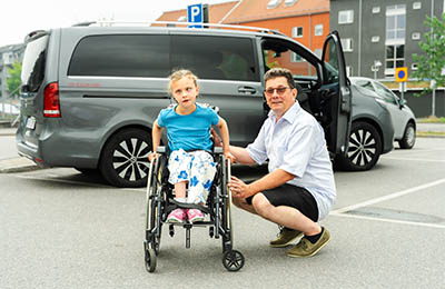 Father next to his daughter in a wheelchair